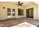 Covered back patio boasts tile flooring, a ceiling fan, and sliding glass doors to the home's interior at 4376 S Santiago Way, Chandler, AZ 85248