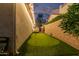 Private backyard putting green with manicured turf, flag poles, and perimeter wall at 4376 S Santiago Way, Chandler, AZ 85248