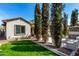 Beautiful backyard, mature trees, lush lawn and decorative hanging flower basket at 4376 S Santiago Way, Chandler, AZ 85248