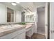 A double sink bathroom with a well lit mirror, vanity, and adjacent access to the bedroom at 4376 S Santiago Way, Chandler, AZ 85248