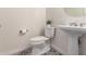 This bathroom features black and white decorative tile flooring and a pedestal sink at 4376 S Santiago Way, Chandler, AZ 85248