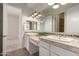 A bathroom with a double sink and view to the bedroom at 4376 S Santiago Way, Chandler, AZ 85248