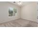 A well-lit bedroom with neutral carpet, ceiling fan, and window shutters for a comfortable ambiance at 4376 S Santiago Way, Chandler, AZ 85248