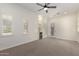 Bedroom with carpet, ceiling fan, plantation shutters and built-in shelving unit at 4376 S Santiago Way, Chandler, AZ 85248