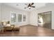 Bedroom features wood floors, plantation shutters, a chair, and a glass slider to an outdoor patio at 4376 S Santiago Way, Chandler, AZ 85248