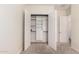 A bedroom closet featuring built in shelving and drawers across from a bathroom at 4376 S Santiago Way, Chandler, AZ 85248