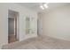 A cozy bedroom with a ceiling fan and mirrored french doors providing access to other rooms at 4376 S Santiago Way, Chandler, AZ 85248