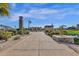 Scenic paved walkway with a clock tower and pergola feature leads to a tranquil pond in this beautiful community at 4376 S Santiago Way, Chandler, AZ 85248