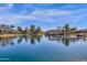 Wide view of a calm community pond reflecting the lush landscaping, covered gazebos, and surrounding homes at 4376 S Santiago Way, Chandler, AZ 85248