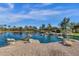 Serene community pond showcases beautiful homes and landscaping reflecting on the water's surface at 4376 S Santiago Way, Chandler, AZ 85248