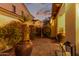 Charming courtyard showcasing gravel, potted plants, and wrought iron gate, enhanced by a beautiful dusk sky at 4376 S Santiago Way, Chandler, AZ 85248