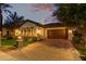 Twilight exterior view of home with a beautiful paved driveway and manicured lawn at 4376 S Santiago Way, Chandler, AZ 85248