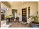 Inviting front porch with seating area, brick pavers, and stylish door at 4376 S Santiago Way, Chandler, AZ 85248