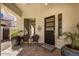 Welcoming front porch with seating, lovely planters and stylish split door at 4376 S Santiago Way, Chandler, AZ 85248