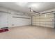 Spacious garage with epoxy flooring, storage racks, and steel garage door at 4376 S Santiago Way, Chandler, AZ 85248