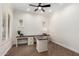 Bright home office featuring plantation shutters and a large desk at 4376 S Santiago Way, Chandler, AZ 85248