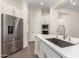 Kitchen island view highlighting stainless steel appliances, quartz countertops, and modern faucet at 4376 S Santiago Way, Chandler, AZ 85248