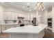 Full kitchen view showcasing long island, stainless steel appliances, and quartz countertops at 4376 S Santiago Way, Chandler, AZ 85248