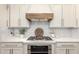 Stylish kitchen showcasing a stainless steel oven, white cabinets, and subway tile backsplash at 4376 S Santiago Way, Chandler, AZ 85248