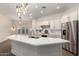 Bright kitchen with a white quartz island, stainless appliances, and modern hanging lights at 4376 S Santiago Way, Chandler, AZ 85248