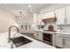 Close up of kitchen island featuring stainless steel oven, white backsplash, and modern faucet at 4376 S Santiago Way, Chandler, AZ 85248