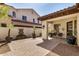 Charming patio with brick pavers, water feature, planters and covered area at 4376 S Santiago Way, Chandler, AZ 85248