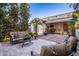 Relaxing outdoor patio with comfortable seating and a covered area with ceiling fans at 4376 S Santiago Way, Chandler, AZ 85248