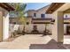 A tranquil patio featuring pavers, a water feature, and lush potted plants at 4376 S Santiago Way, Chandler, AZ 85248