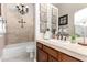 Charming bathroom features a shower-tub combination, vanity with mirror, and decorative wall art at 4438 E Millbrae Ln, Gilbert, AZ 85234