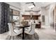 Bright dining area with a round table, four chairs, and sliding glass doors offering scenic views at 4438 E Millbrae Ln, Gilbert, AZ 85234