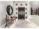 Elegant foyer with a dark wood door, decorative mirror, and a bench for a welcoming entrance at 4438 E Millbrae Ln, Gilbert, AZ 85234