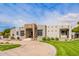 Desert landscaping complements this inviting single-story home with circular driveway at 4438 E Millbrae Ln, Gilbert, AZ 85234