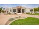 Inviting single-story home featuring desert landscaping and a circular driveway at 4438 E Millbrae Ln, Gilbert, AZ 85234