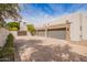 Spacious three car garage with stone accents and concrete driveway, perfect for car enthusiasts and storage at 4438 E Millbrae Ln, Gilbert, AZ 85234