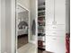 A peek into a bedroom from a hallway reveals a large storage closet with bright white built-ins at 4438 E Millbrae Ln, Gilbert, AZ 85234