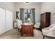 This home office features a wooden desk and complementary furniture, all illuminated by natural light from the window at 4438 E Millbrae Ln, Gilbert, AZ 85234