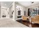 Inviting living room with wicker chairs, hardwood floors, and seamless flow from the foyer at 4438 E Millbrae Ln, Gilbert, AZ 85234