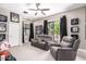 Comfortable living room with plush seating, ceiling fan, and sports memorabilia decor at 4438 E Millbrae Ln, Gilbert, AZ 85234
