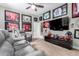 Relax in this carpeted living room with reclining chairs, a ceiling fan, recessed lighting, and sports memorabilia at 4438 E Millbrae Ln, Gilbert, AZ 85234