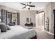 Bright main bedroom with ceiling fan, patio door, and ensuite access at 4438 E Millbrae Ln, Gilbert, AZ 85234