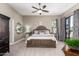 Nicely styled main bedroom features a ceiling fan, ensuite bathroom and patio door at 4438 E Millbrae Ln, Gilbert, AZ 85234