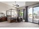 Light filled primary bedroom boasts a canopy bed, sitting area and private patio access at 4438 E Millbrae Ln, Gilbert, AZ 85234
