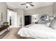 A main bedroom displays a dark wood armoire, mirror, and access to a bathroom and the bedroom entry at 4438 E Millbrae Ln, Gilbert, AZ 85234