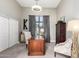 Bright home office featuring wood desk, patterned chairs, and ample storage at 4438 E Millbrae Ln, Gilbert, AZ 85234