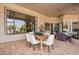 Covered patio with dining table and chairs, creating an inviting outdoor living space for meals and gatherings at 4438 E Millbrae Ln, Gilbert, AZ 85234