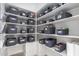 Organized pantry features white shelving and stylish gray storage bins for optimal kitchen storage at 4438 E Millbrae Ln, Gilbert, AZ 85234