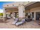 Spacious covered patio featuring lounge chairs and outdoor seating area, perfect for relaxing and entertaining at 4438 E Millbrae Ln, Gilbert, AZ 85234