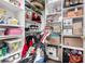 Organized walk-in closet features shelving and hanging storage for clothes, accessories and household goods at 4438 E Millbrae Ln, Gilbert, AZ 85234