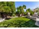 Serene backyard featuring lush greenery, swing, and pool, creating a private outdoor retreat at 4444 W Chama Dr, Glendale, AZ 85310