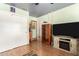 Guest room featuring a large TV with modern console, closet and wooden decor at 4444 W Chama Dr, Glendale, AZ 85310